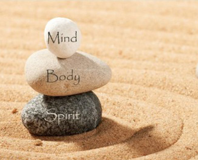 Mind Body Spirit text on stacked rocks