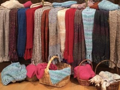 Prayer Shawls displayed on a table and in basket