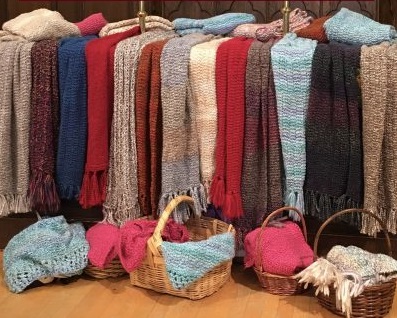 Prayer Shawls displayed on a table and in basket