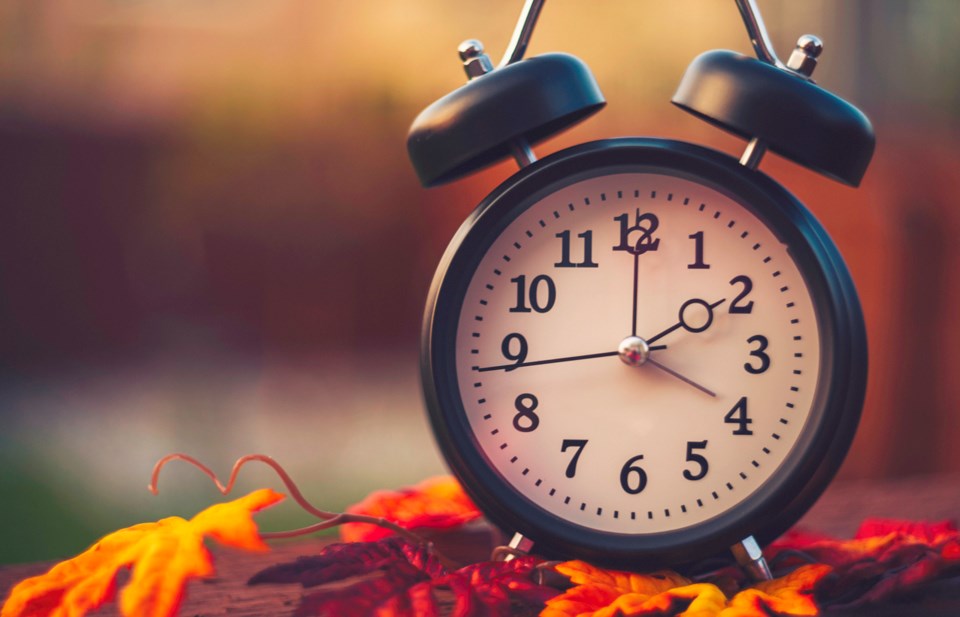 photo of clock and fall foliage